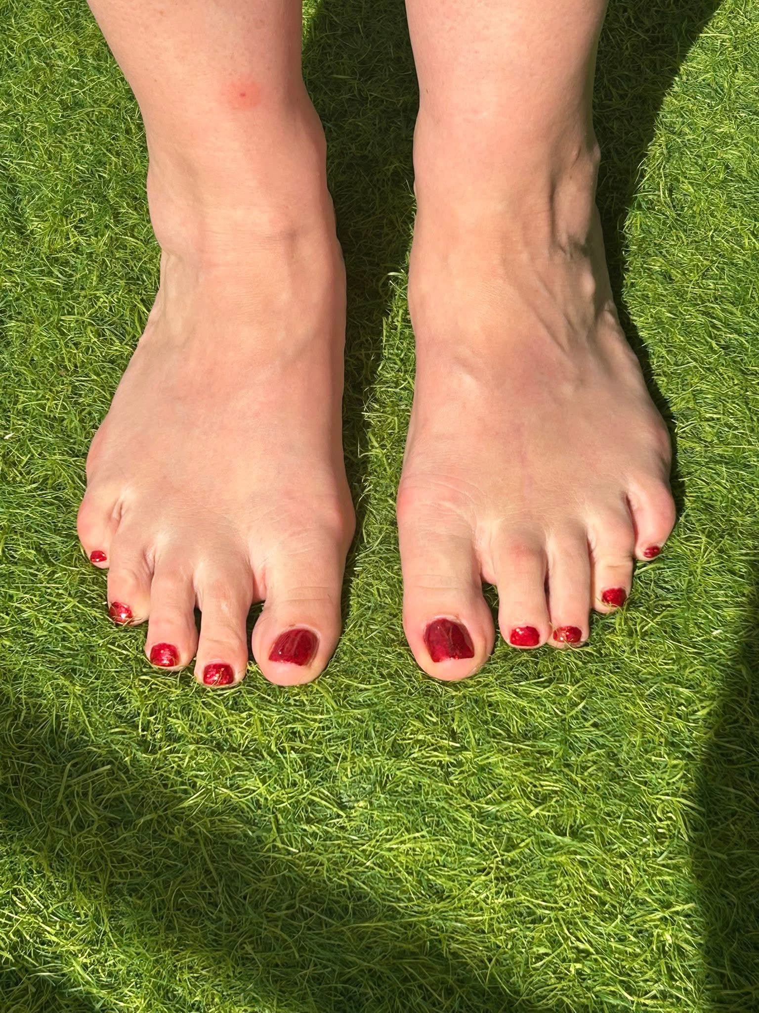Pedicure with red nail polish by The Beauty Spectrum